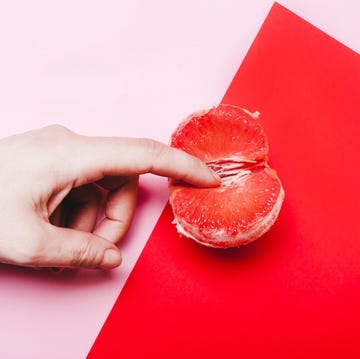 finger touching a clementine