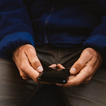 hands holding a smartphone while seated